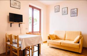a living room with a table and a couch at Villa Paradiso Brenzone in Brenzone sul Garda