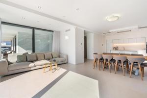 a living room with a couch and a table and chairs at ViLLA LA SELVA PGA in Girona