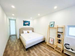 a bedroom with a bed in a room at Eco Nest Apartment & Hotel Nam Ngư in Hanoi