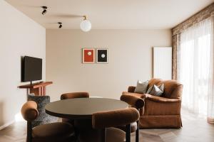 a living room with a table and chairs at Reykjavik Residence Apartment Hotel in Reykjavík