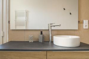 a bathroom with a white sink on a counter at Le May Flower - 3 Chambres - Proche Centre-Ville in Troyes +10 photos