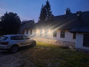 a car parked in front of a house at night at Viktory II in Vlasic +4 photos