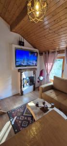 a living room with a couch and a flat screen tv at Viktory II in Vlasic