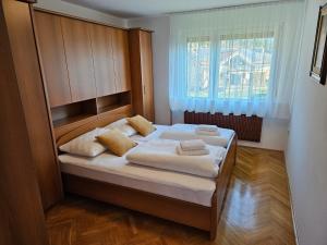 a bedroom with a bed with white sheets and a window at Apartment Josipina in Preddvor