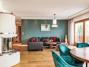 a living room with a couch and a table at Apartment Panorama Dachstein by Interhome in Rohrmoos