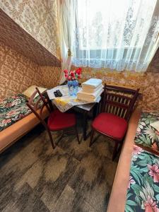 a small room with a table and chairs and a window at Privát Mulík in Stará Lesná +18 photos