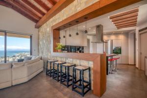a kitchen and living room with a couch and a bar at VenMar luxury house in Platanias