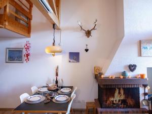 una sala da pranzo con tavolo e camino di Apartment Les Arsets 308-15 by Interhome a Taveyannaz