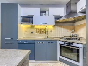 a kitchen with blue cabinets and a sink at Holiday Home Bonita by Interhome in Šišan