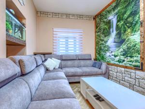 a living room with a couch and a large painting at Holiday Home Bonita by Interhome in Šišan +15 photos