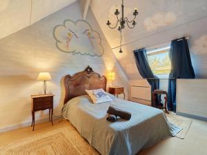 a bedroom with a bed and a chandelier at Holiday Home La longère by Interhome in Vatteville-la-Rue