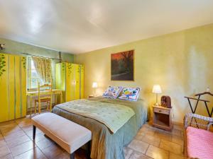 a bedroom with a bed and a chair at Holiday Home La longère by Interhome in Vatteville-la-Rue