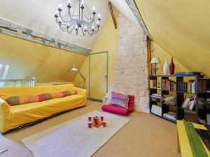 a living room with a yellow couch and a book shelf at Holiday Home La longère by Interhome in Vatteville-la-Rue +34 photos