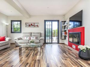 a living room with a couch and a fireplace at Holiday Home Torre de Ven by Interhome in Vidreres
