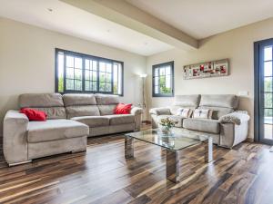a living room with two couches and a glass table at Holiday Home Torre de Ven by Interhome in Vidreres