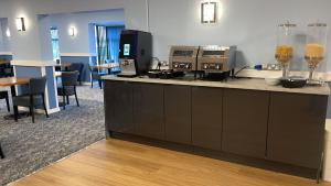 a kitchen with a counter with some food on it at Britannia Hotel Wigan in Standish +23 photos