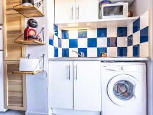 a laundry room with a washer and dryer in a kitchen at Apartment Primavera-4 by Interhome in Agde