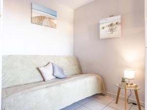 a small bedroom with a bed and a table at Apartment Primavera-4 by Interhome in Agde