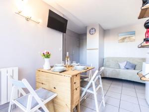 a kitchen and living room with a table and chairs at Apartment Primavera-4 by Interhome in Agde +17 photos