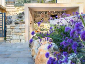 a garden with purple flowers in front of a building at Holiday Home Botra Maria Luxury by Interhome in Sveti Petar u Šumi