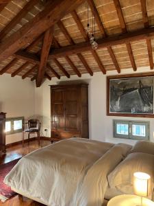 a bedroom with a large bed and a wooden ceiling at Locanda San Martino in San Martino in Rio +25 photos