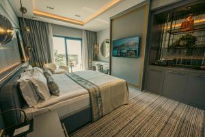 a hotel room with a bed and a television at Chamada Prestige Hotel and Casino in Kyrenia +62 photos
