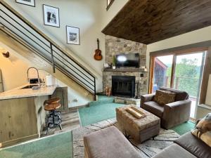 a living room with a couch and a fireplace at Condo at Lutsen Mtn, Ski in Ski out, Hike, Bike, Ski, Swim, etc in Lutsen