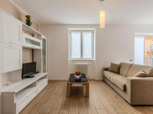 a living room with a couch and a table at Apartment Il Melo-1 by Interhome in Garzeno
