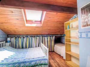 a bedroom with a bunk bed and a window at Holiday Home Faisans by Interhome in Ondres