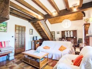 a living room with a couch and a table at Holiday Home Faisans by Interhome in Ondres