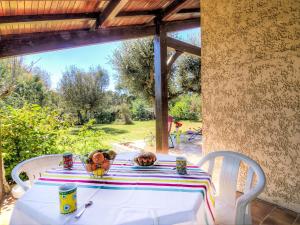 a table with a white table cloth on a patio at Holiday Home Faisans by Interhome in Ondres