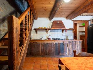 a kitchen with a wooden staircase and a stove at Apartment Baita del Celtico 2 by Interhome in Advise
