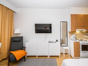 a living room with a white cabinet and a kitchen at Holiday Home Rautulampi g14 by Interhome in Saariselka