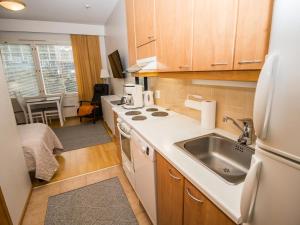a small kitchen with a sink and a stove at Holiday Home Rautulampi g14 by Interhome in Saariselka