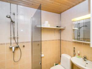 a bathroom with a shower and a toilet and a sink at Holiday Home Rautulampi g14 by Interhome in Saariselka +5 photos