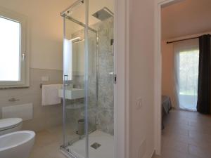 a bathroom with a shower and a toilet and a sink at Holiday Home Mirto Marino-4 by Interhome in Costa Rei