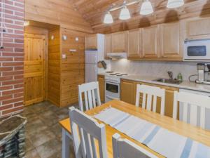 a kitchen and dining room with a table and chairs at Holiday Home Alakoski by Interhome in Ivalo