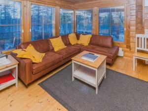 a living room with a brown couch and yellow pillows at Holiday Home Alakoski by Interhome in Ivalo