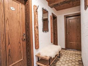 an empty room with a door and a bench at Apartment Ferienwohnung Gartenblick by Interhome in Öblarn