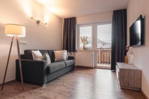 Televízia a/alebo spoločenská miestnosť v ubytovaní Alpen-Appartements Zürcher