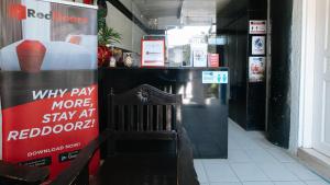 a room with a red moon sign and a chair at RedDoorz at Plus Villa Gloria Taguig in Manila