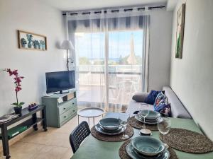 a living room with a table with plates on it at Apartment Sotavento by Interhome in Los Amarguillos