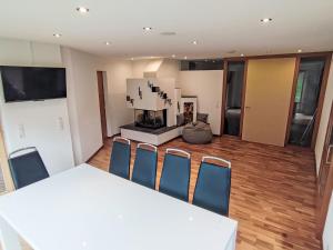 a room with a table and chairs and a fireplace at Apartment Bella Monte-5 by Interhome in Pettneu am Arlberg +20 photos