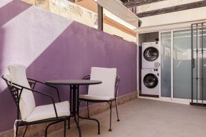 a table and chairs in a room with a washing machine at Dream Vacation at Casa Vicki in Almería