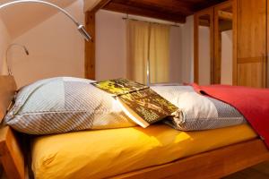 a bed with a lamp on top of it at Wohlfühloase im Grünen "Lindensalettl" in Breitenberg