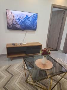 a living room with a table and a tv at Kilimani Luxurious 2 bedroom in Nairobi