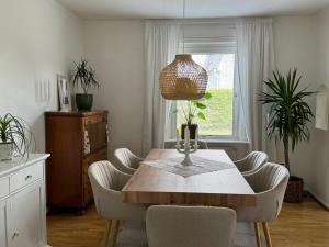a dining room with a wooden table and chairs at Emil Hemma in Järnforsen +29 photos