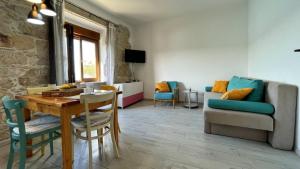a living room with a table and a couch at Apartments Gorisek in Šilo