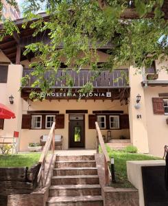 a staircase leading to the front of a building at HOSTERÍA SAJONIA in Villa Gesell