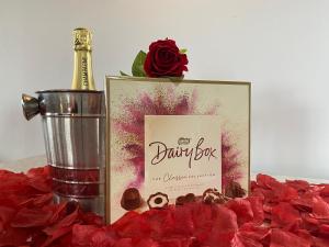 a picture of a bottle of champagne and red roses at Kaoglen Squirrel Drey-Hot Tub-Pet Friendly-Perth in Balnald +24 photos